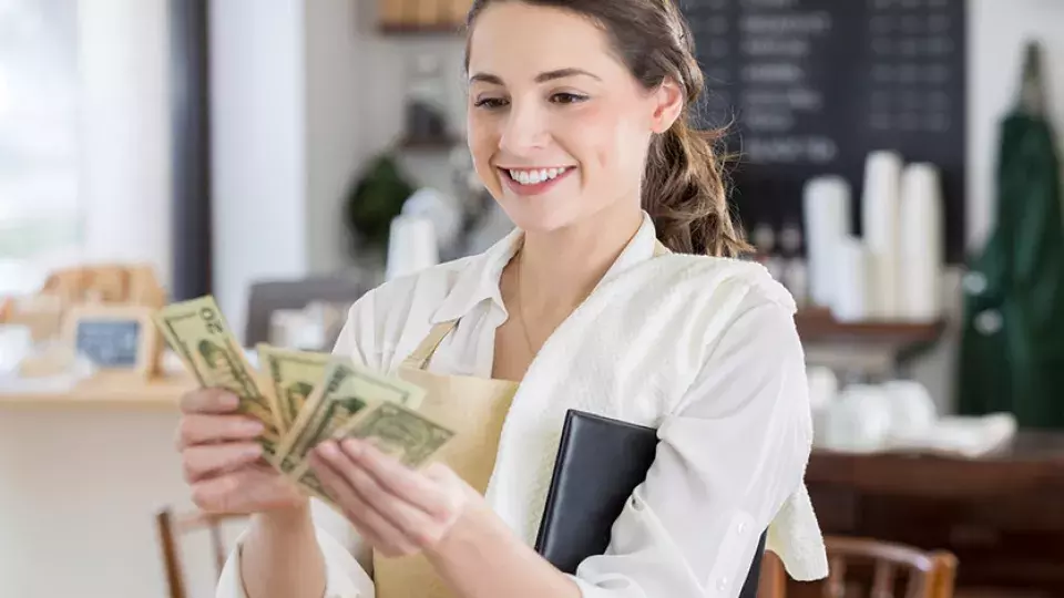 Restaurant employee holding cash