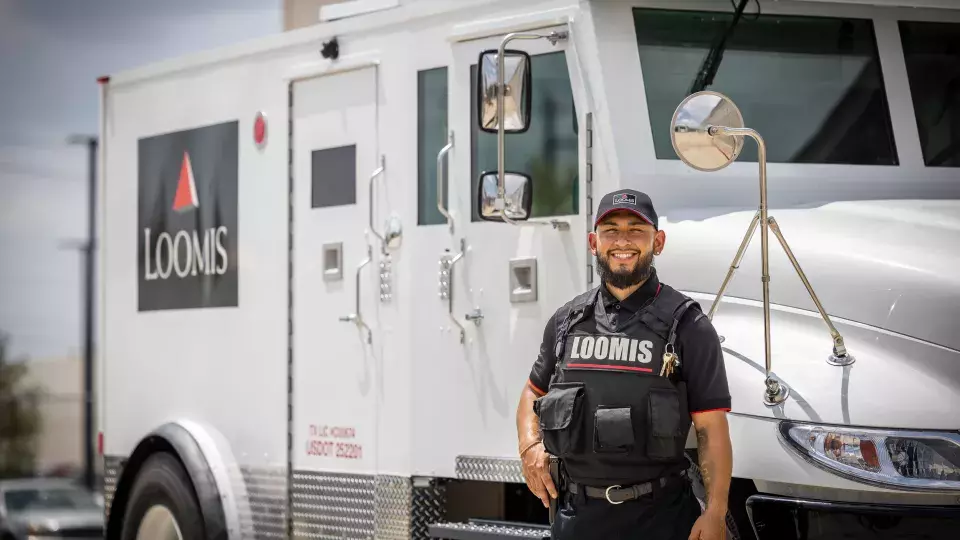 Armored guard standing in front of truck