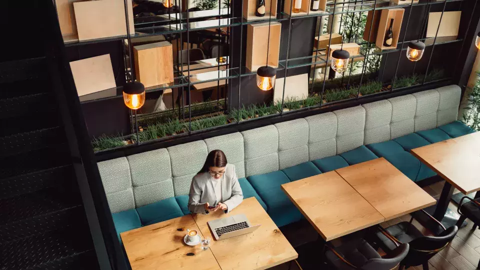 Aerial view of woman in a cafe sitting with her laptop