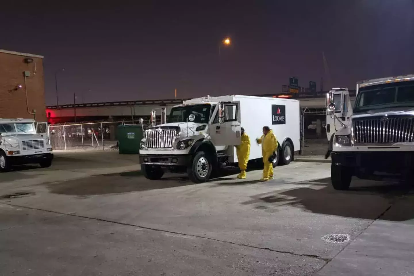 Loomis employees in an armored truck bay