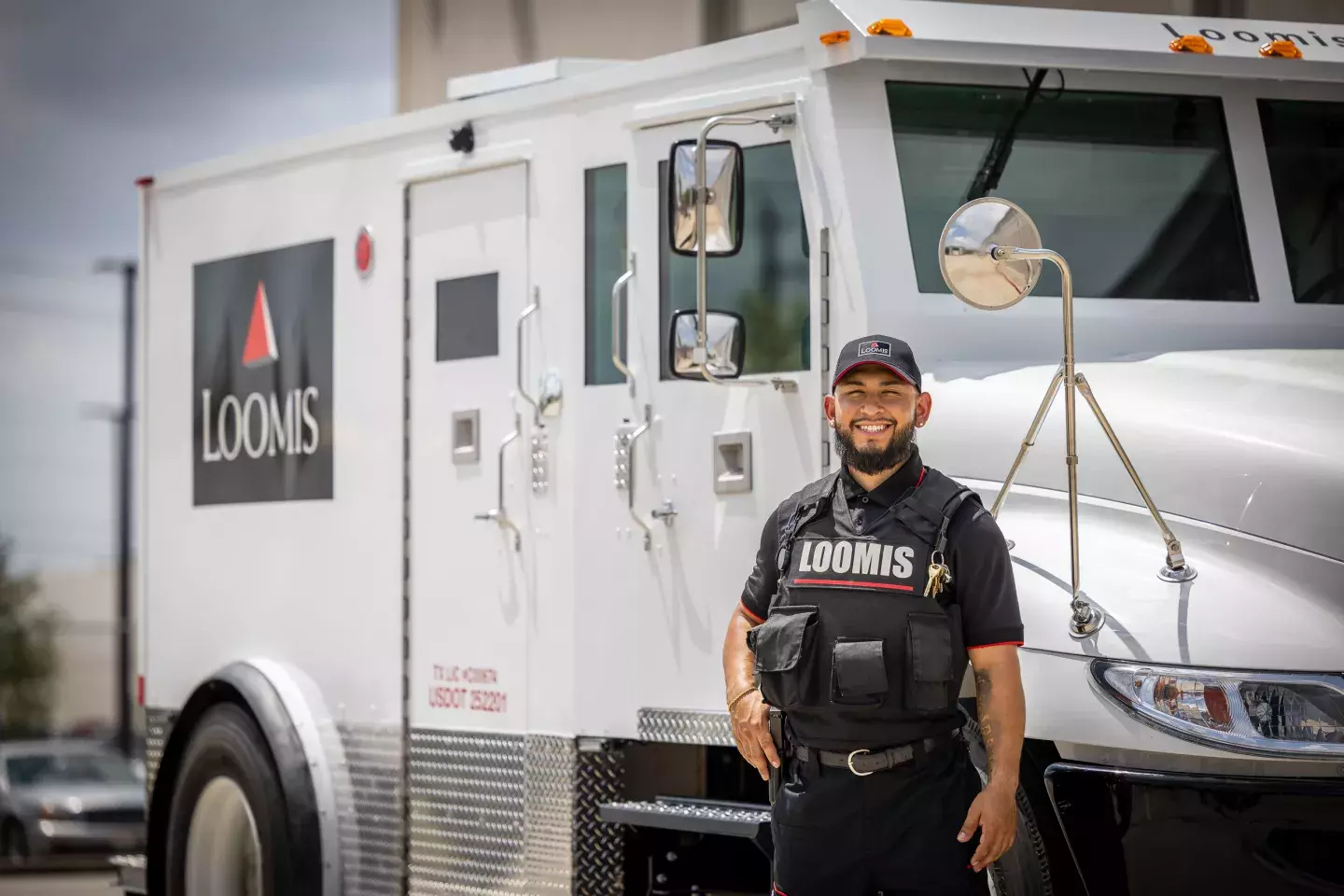 Armored guard standing in front of truck